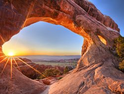 Sunset through an arch in Arches NP
