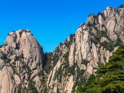 Huangshan National Park vertical rises with blue sky background